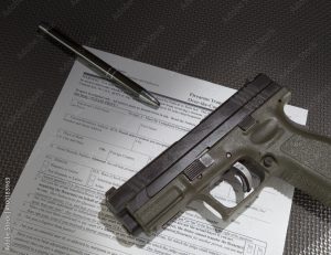 Handgun and the paperwork to get a background check before taking ownership